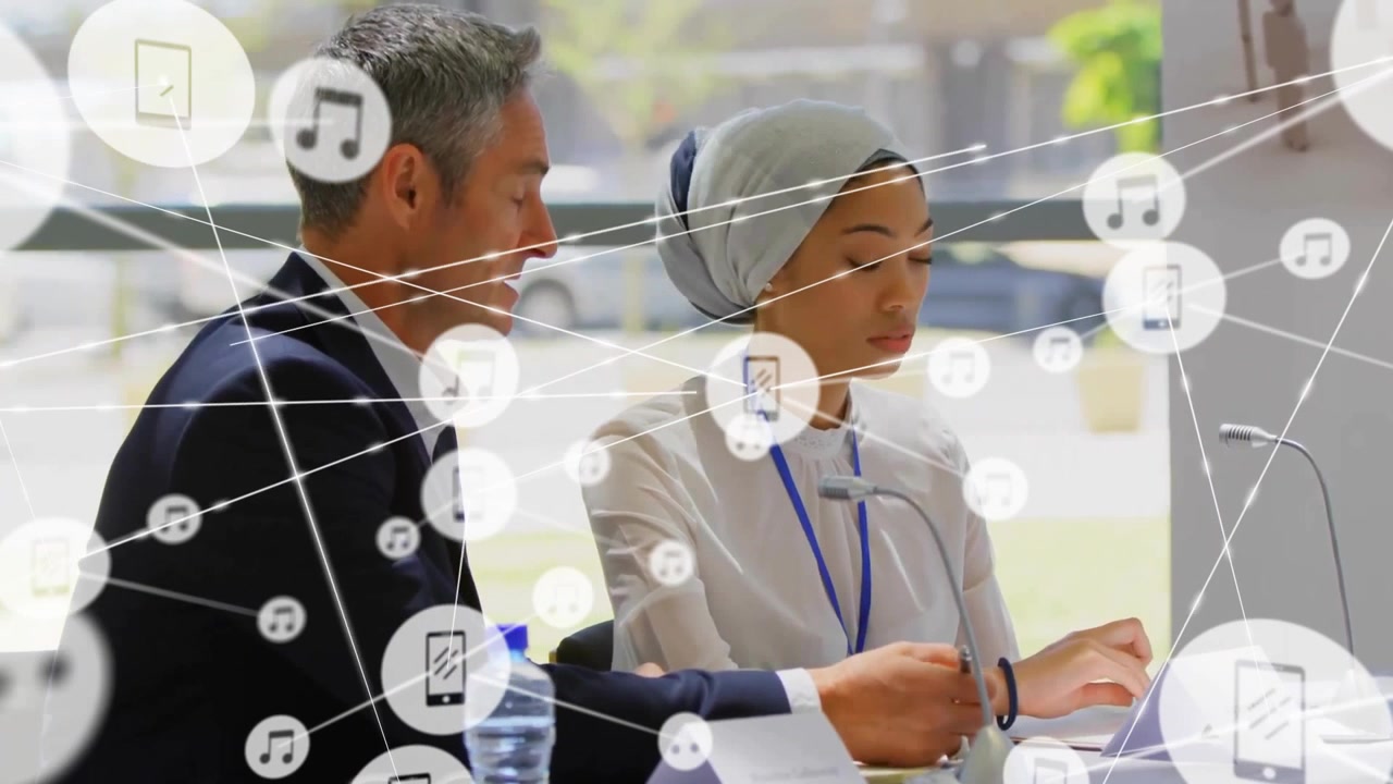 Animation of network of connections with icons over diverse colleagues having meeting in office