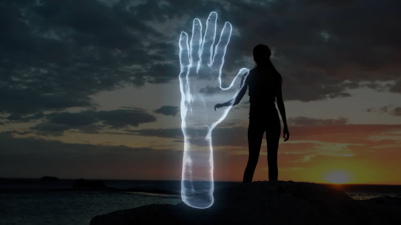 Interacting with glowing hand animation, person silhouetted against sunset sky