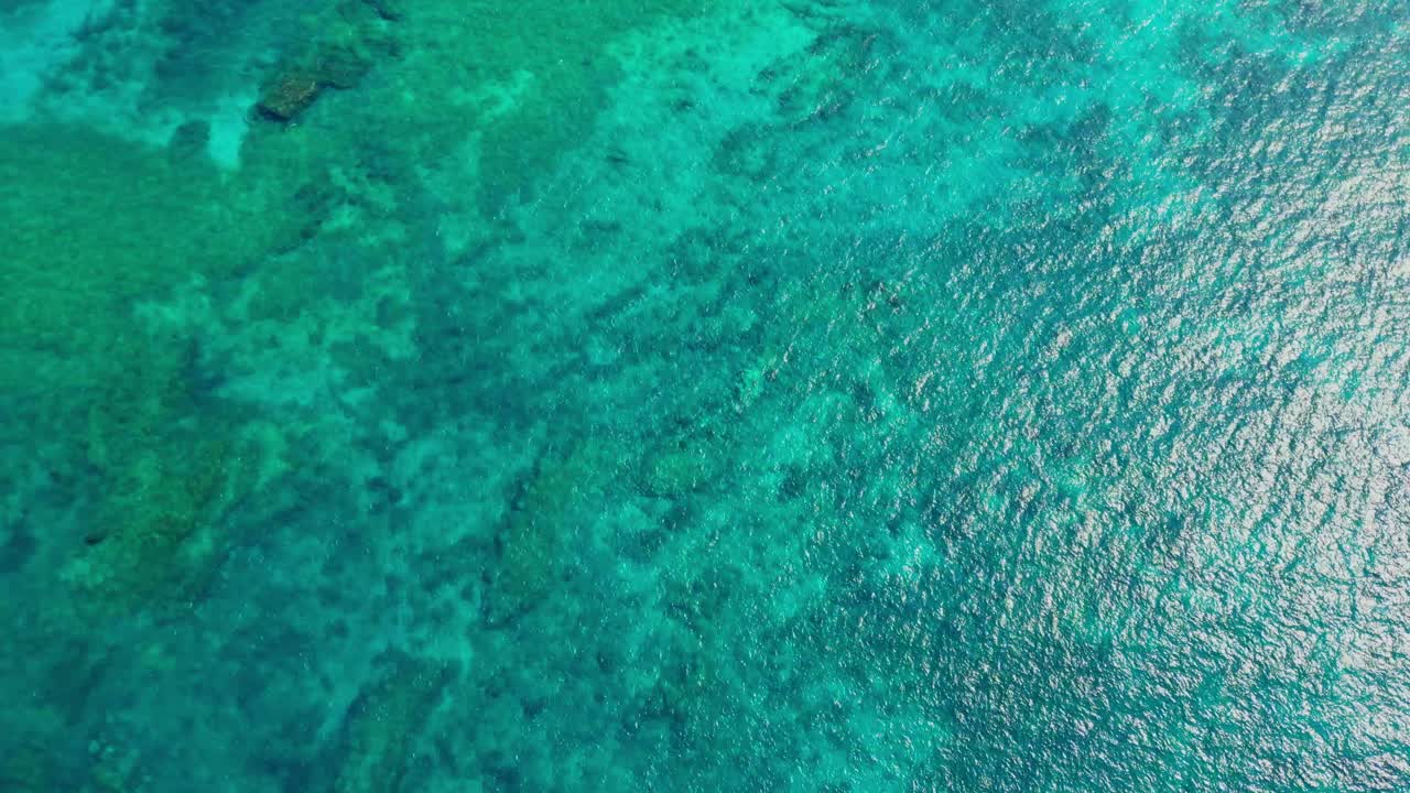 Bird's eye view of the magnificent turquoise sea with the sun reflecting . Transparent sea that allows you to see the bottom of the sea. Ilha do Principe (Prince Island) Sao Tome,Africa
