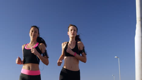 friends running on promenade for summer fitness