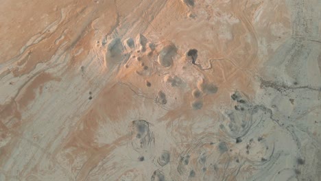 aerial drone above the desert with holes in the grounds at judaean desert