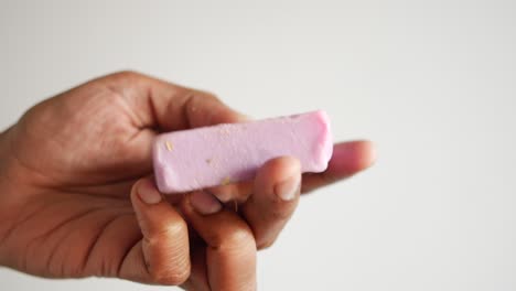 holding a homemade natural soap bar ,