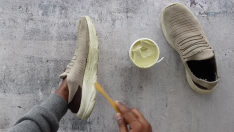 a person cleaning a pair of sneakers