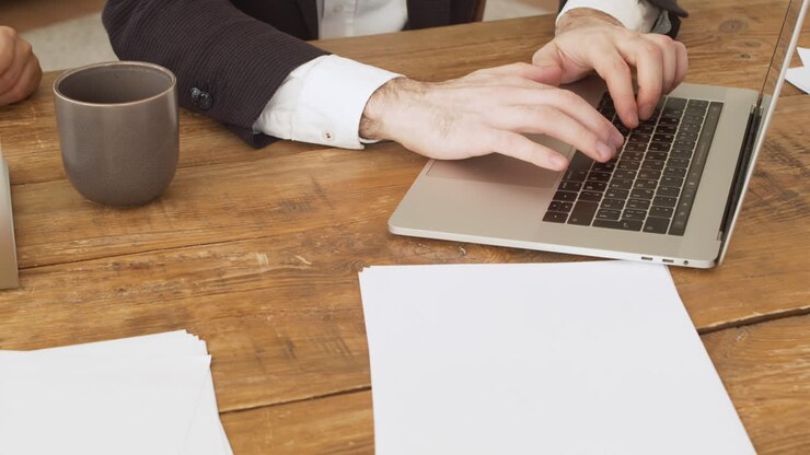 Close Up Of An Unrecognizable Businessman's Hands Typing On Laptop Computer