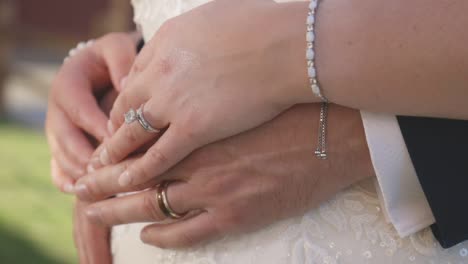 bride rests her hands on the grooms hands