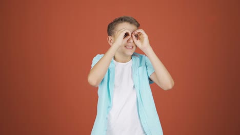 Boy-with-binoculars-looking-away.