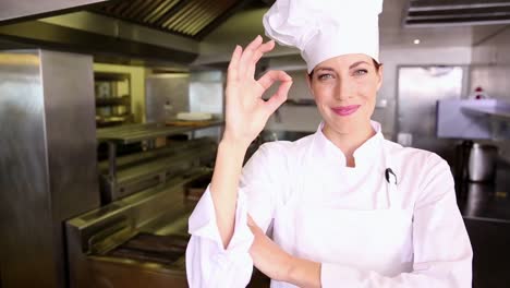Pretty-chef-making-ok-sign-to-camera