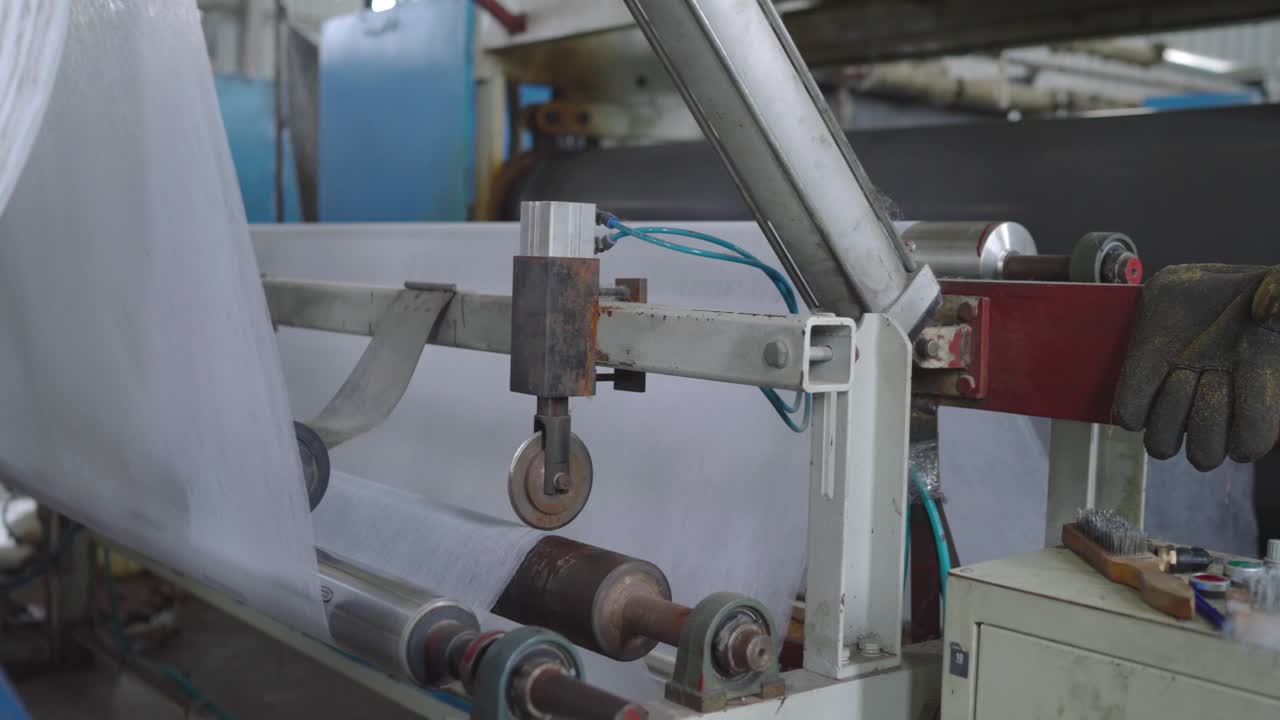 Advanced textile machinery in action at a factory, showcasing efficient fabric production with precision and modern technology