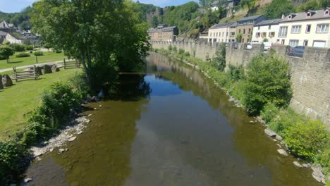 View-on-a-stream-through-Le-parc-de-rompré-in-La-Roche-en-Ardenne,-Ardennes,-Belgium,-Europe,-4K,-50fps