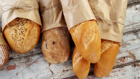 various types of breads wrapped in paper bag