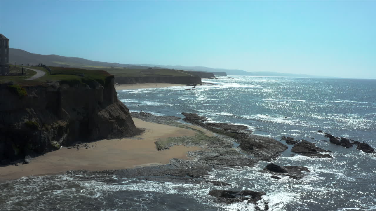 Aerial Drone sliding shot of the cliffs overlooking the crushing waves at Half Moon. Bay, California, USA