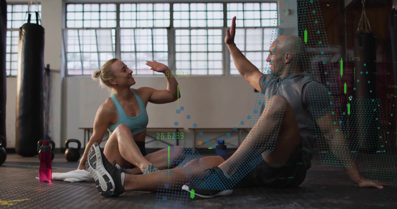 Gym partners resting, talking then high-fiving, celebrating while data graphics sweeping over pair
