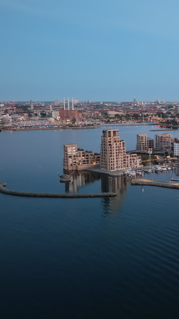 Aerial drone view of Osterbo Nord, Nordhavn harbour area at the coast of the Oresund at sunset. Vertical