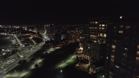 city of mar del plata at night in argentina. aerial view of urban tall buildings and park.