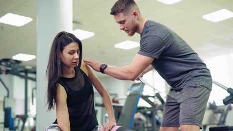young and beautiful woman working out with dumbbells in gym. personal fitness instructor. personal training.