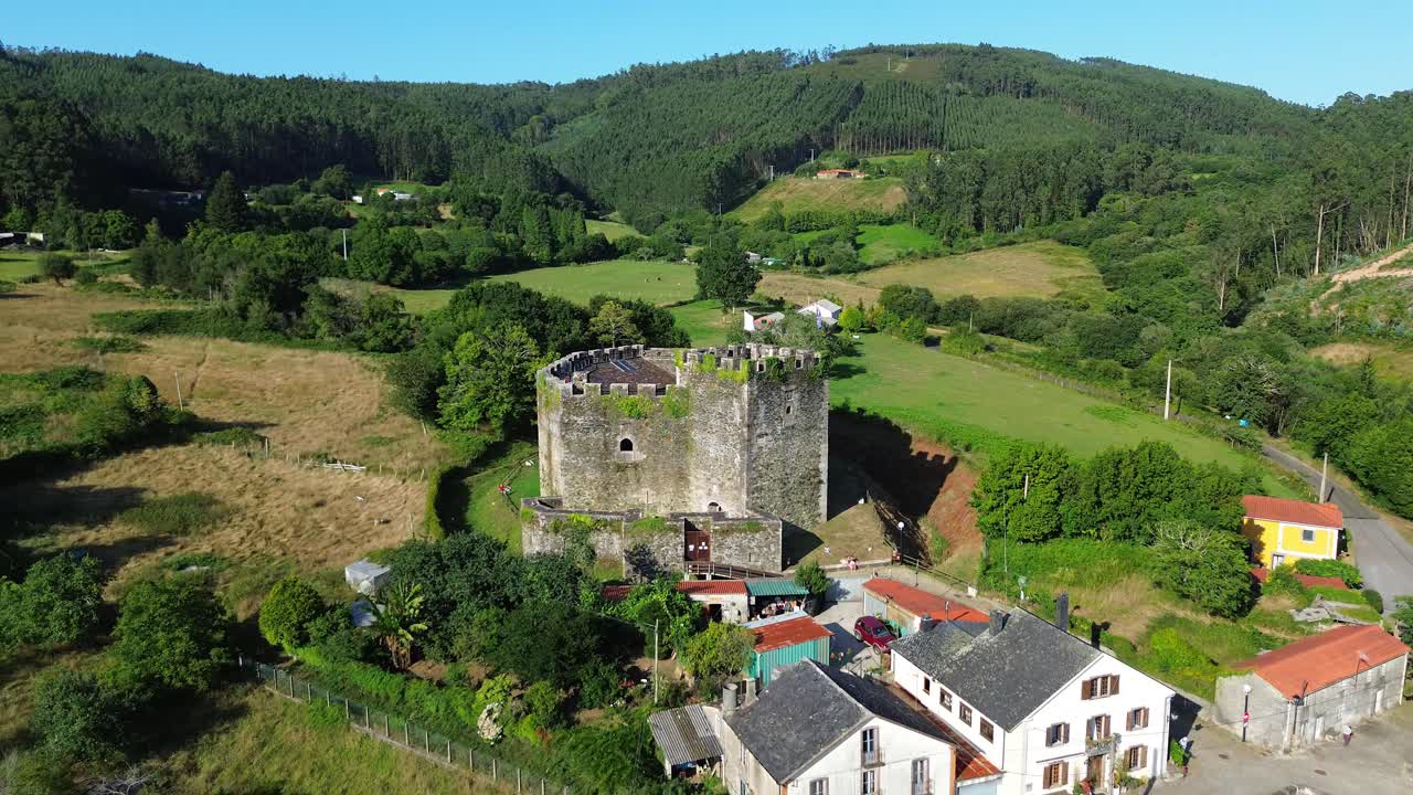 Small medieval castle surrounded by lush green hills near Lugo, Galicia