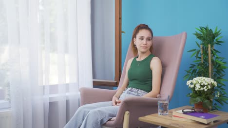 depressed woman. the woman is watching out the window.