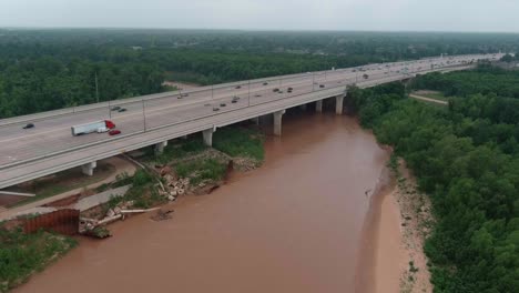 Aerial-of-cars-on-59-South-as-the-pass-over-the-Brazos-River-in-Sugarland,-Texas