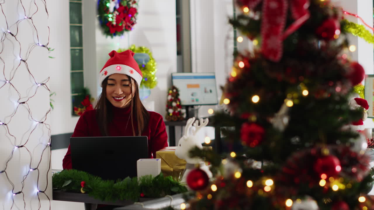 A group celebrates Christmas with gifts and a decorated tree