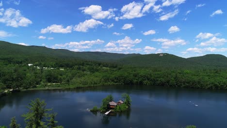 drone footage of serene nh white mountains lake, isolated island house, and natural beauty