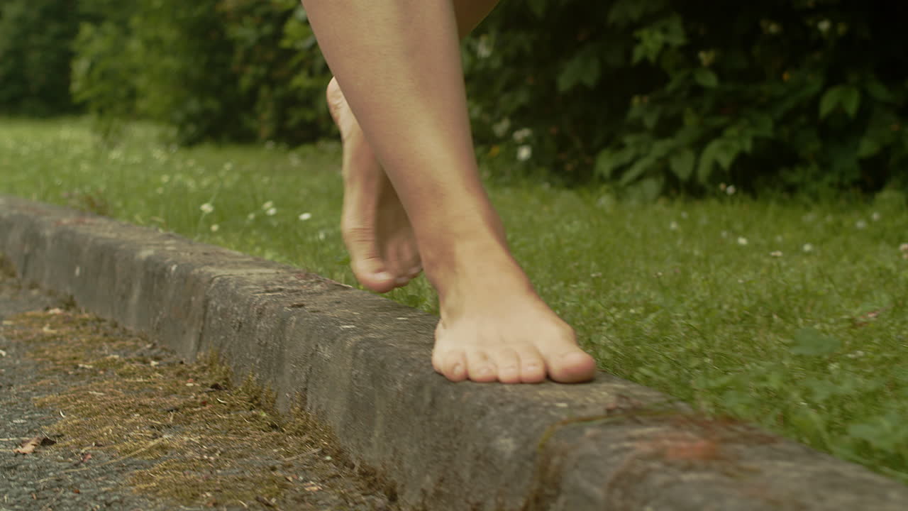 Female Bare Feet Walk Along Street Curb, Slow Motion, Low Angle Free Stock  Video Footage Download Clips