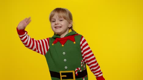 Girl-in-Christmas-elf-Santa-helper-costume-waving-greeting-with-hand.-Hello,-hi,-greetings-gesture