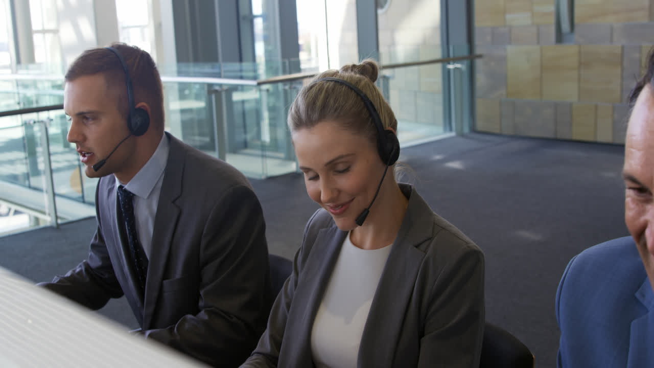 Giovani professionisti che indossano cuffie in un ufficio moderno