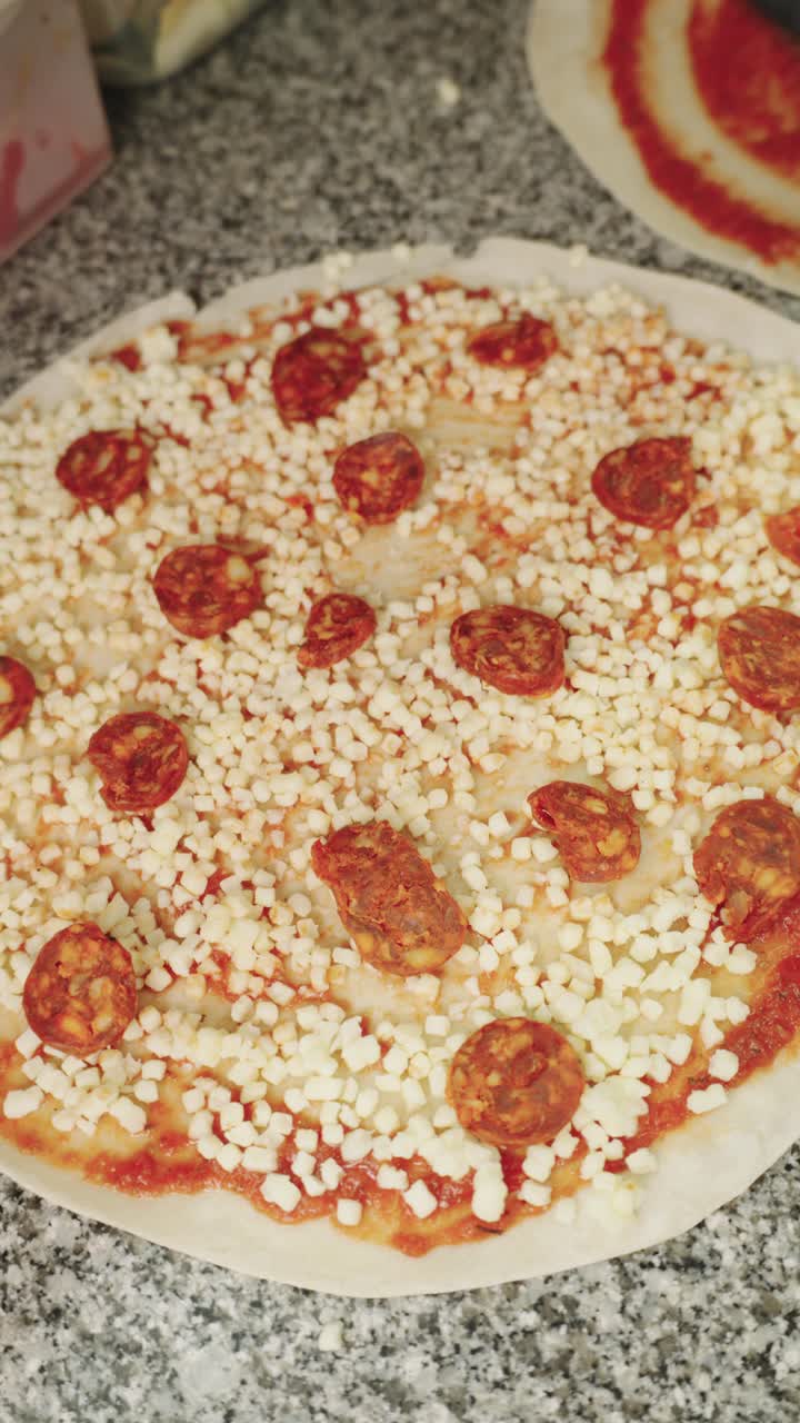 Making pepperoni pizza