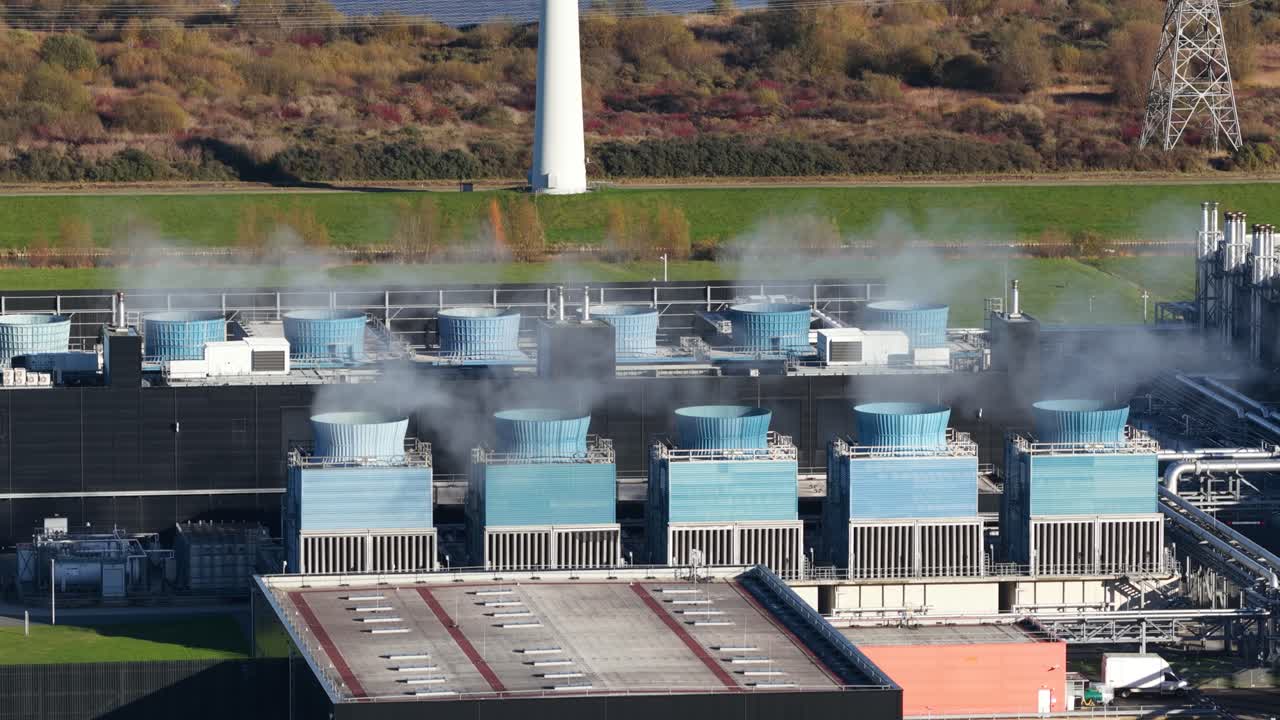 cooling fans hardware on top of the roof of a large scale data center in the Eemshaven, The Netherlands. Aerial drone close up video