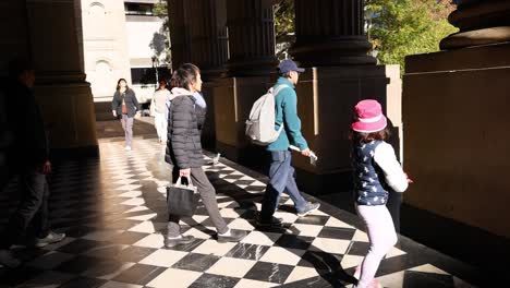 pedestrians walking near state library victoria entrance