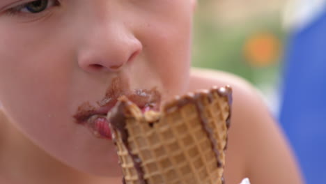 boy eating chocolate ice cream cone