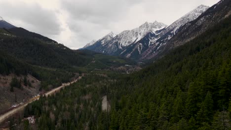 Drone-shot-of-forest-and-mountains-near-Duffey-Lake-in-British-Columbia,-Canada