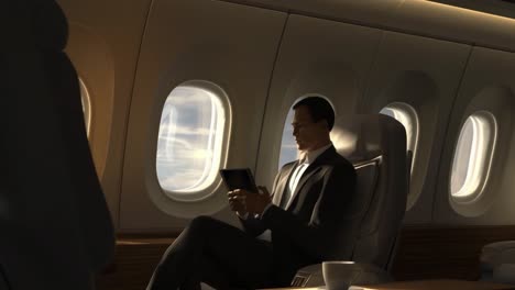 man in suit using tablet on luxury airplane