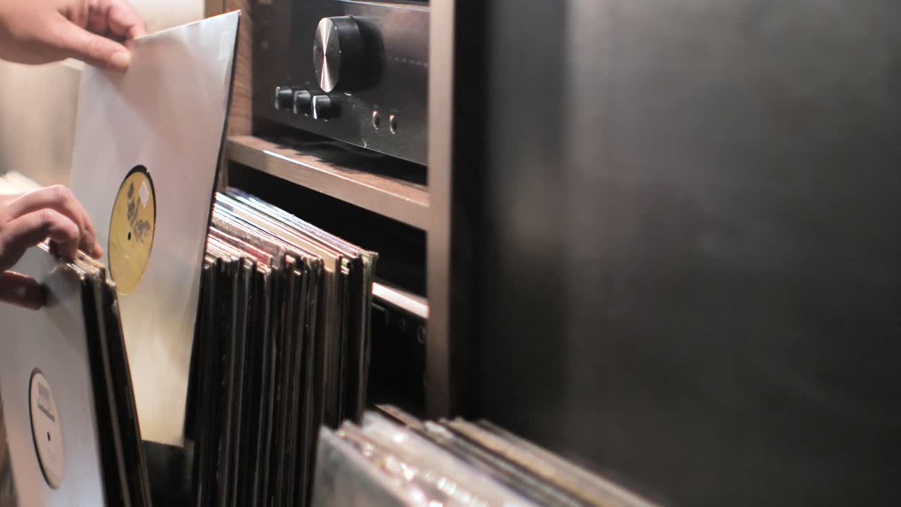 Close up man hands browsing vintage vinyl records at home. Searching music on a vinyl. Scene C