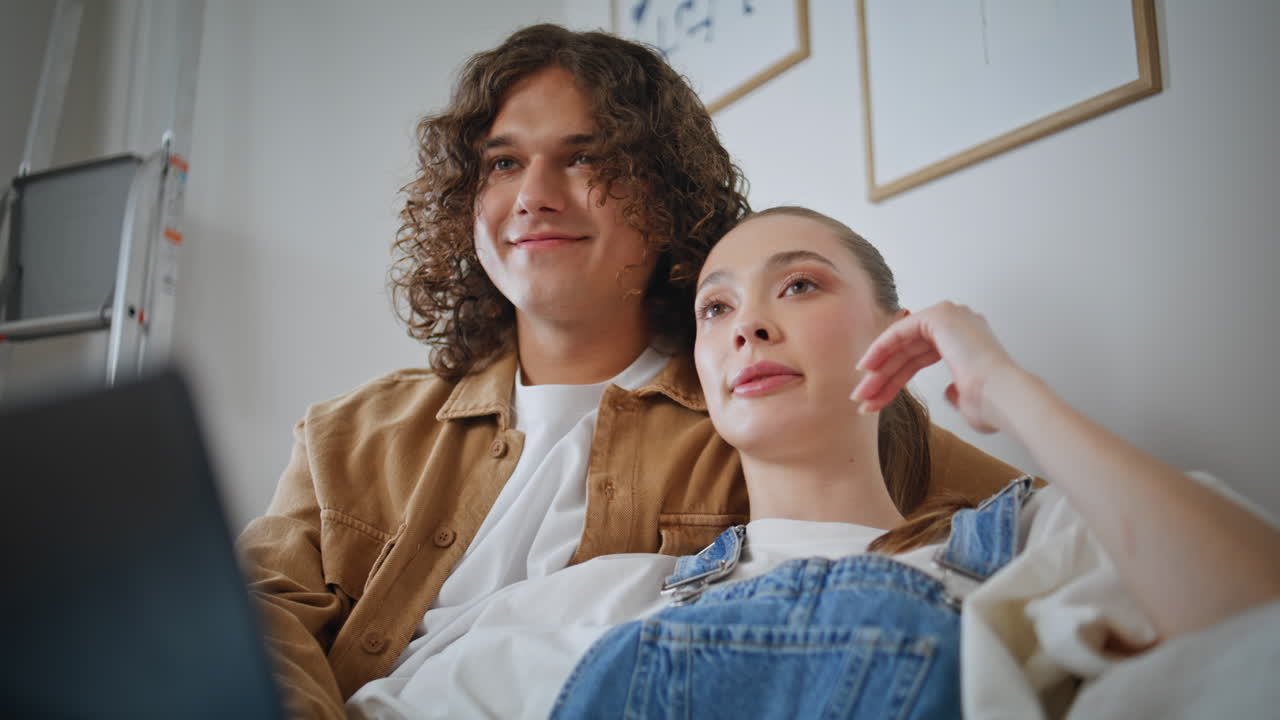 Married man woman planning decor new home sitting on sofa with laptop closeup