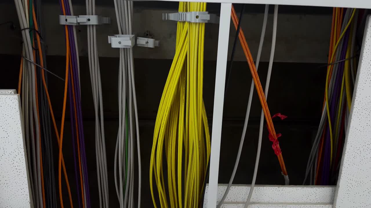 Bottom up shot showing modern network cabling in ceiling of modern company,close up dolly