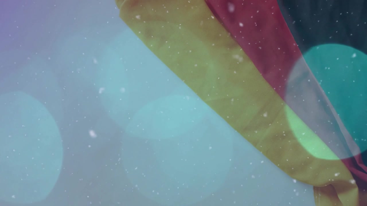Drapeau allemand avec des flocons de neige et des lumières bokeh bleues.