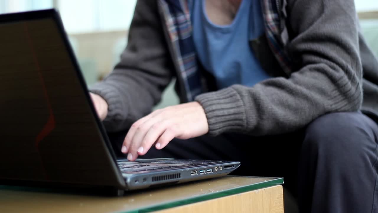 Close Up Shot Of Man'S Hands Working A Laptop Keyboard And Mouse