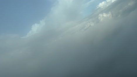 unique aerial view pilot’s fpv of the silhouette (anthelion) of a jet airplane over the clouds when crossing them on a right turn descending. 4k