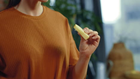 woman cutting red apple on kitchen desk