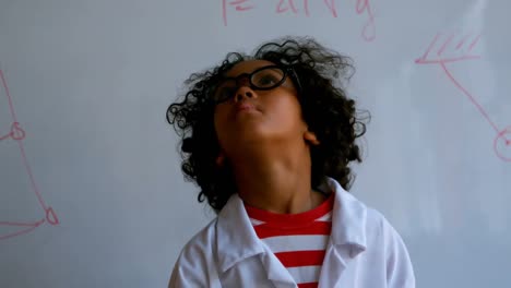 pretty african-american schoolboy standing in laboratory at school 4k