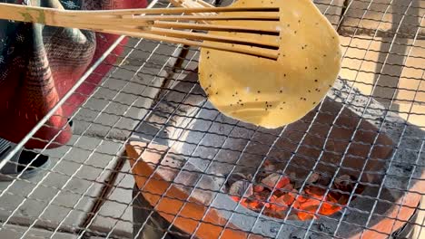 rice cracker being cooked on a charcoal grill