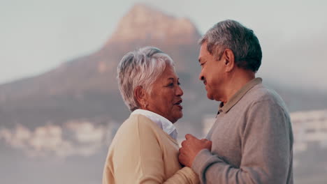 elderly couple holds hands
