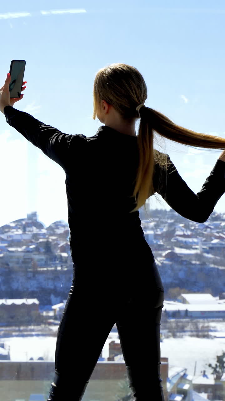 Businesswoman with mobile phone in hand. Pretty young businesswoman making selfie at workplace