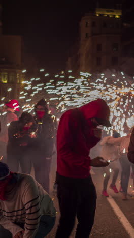 barcelona, spain - 22 september 2023 : crowds in the street for the fire run or correfoc, during la merce festival, barcelona spain in vertical