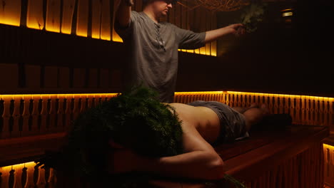 man receiving a traditional sauna treatment