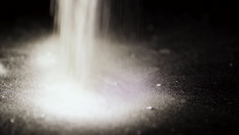 powder pouring on dark surface