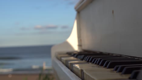 white piano on the beach