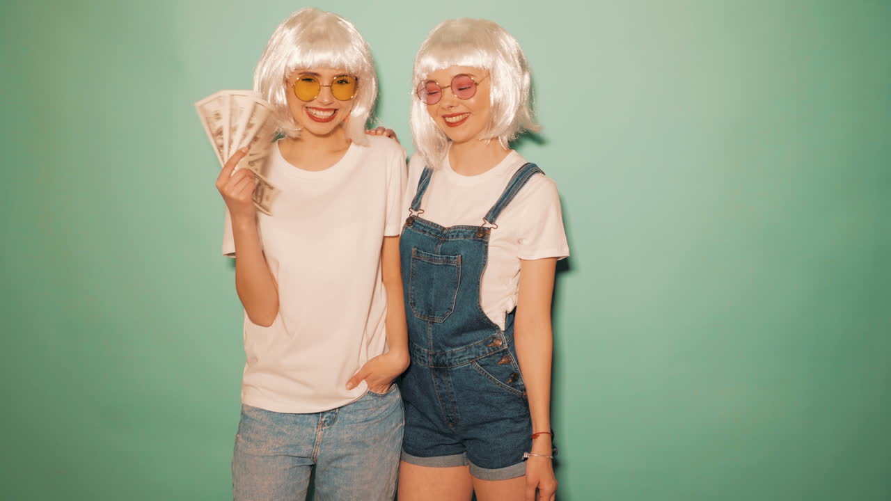 Happy Twin Girls Posing with Money