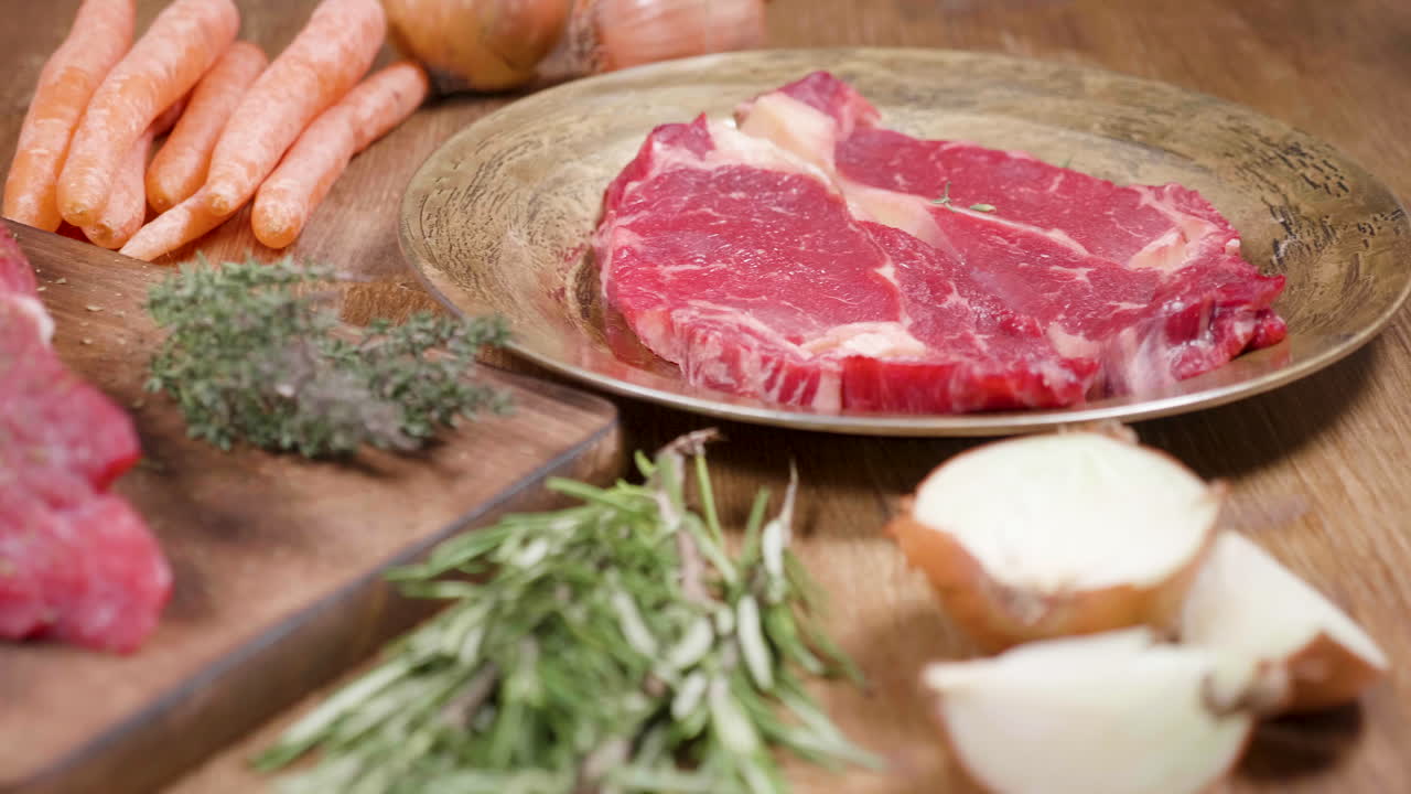 Raw Beef Steaks with Vegetables and Herbs